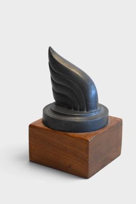 sculpture of a winged wing on a wooden base on a white background