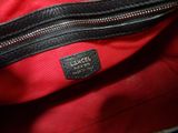 a close up of a red purse with a black handle