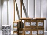 many boxes of mail sitting on a table in a storage room