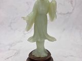 statue of a woman holding a flower in her hand on a marble surface