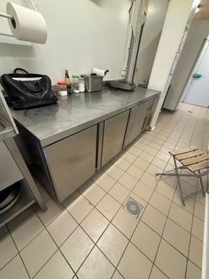 a kitchen with stainless steel counter tops and stainless steel cabinets