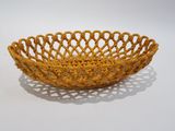 a close up of a yellow bowl on a white surface