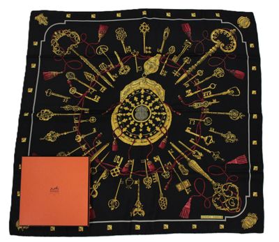a black scarf with gold keys and keys on it
