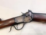 a close up of a gun on a table with a white background
