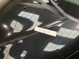 a sticker on the windshield of a black car