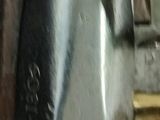 a close up of a piece of metal with a clock on it