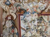 a painting on the wall of a room with a vase of flowers in it