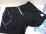 a pair of shorts that are laying on a bed