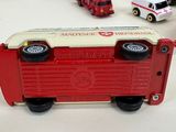 a lot of toy firetrucks and trucks on the table