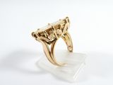 an image of a gold ring with a large stone in the center