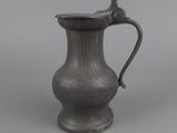 an image of a pewware pitcher on a gray background