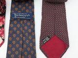 four different ties laid out on a white surface