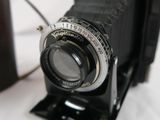 a black camera sitting on top of a white table