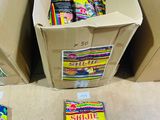 many boxes of candy sitting on the floor next to each other