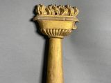 a gold candle holder on a gray background