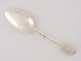 silver spoon on a white surface with a silver spoon in the middle of it