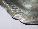 a silver plate on a table with a white table cloth