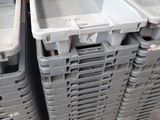many plastic containers stacked on a pallet in a warehouse