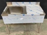 an image of a stainless steel sink sitting on top of a table