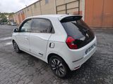 a picture of a small white car parked in a parking lot