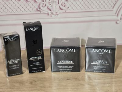 three boxes of lancome cosmetics sitting on a table