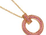 an image of a gold necklace with pink stones on a white background