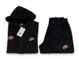a black jacket and pants with a pink nike logo on it