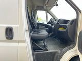 a white van with the door open and the driver ' s seat down