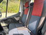 a seat in the back of a van with a red seat cover