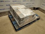 a stack of boxes on a pallet in front of a wall
