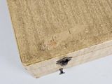 a close up of a piece of wood that has a small bird on it