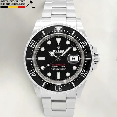 the rolex watch has a black dial and black bezel