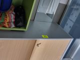 a green shelf with cleaning supplies on top of it