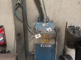 a blue machine that is sitting in a garage