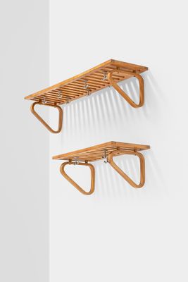 a pair of wooden shelves mounted on a wall
