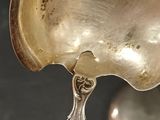 a silver spoon and a silver spoon on a table