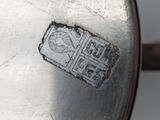 a piece of metal that has a stamp on it