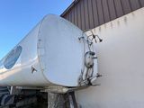 a large white tank sitting on the side of a building
