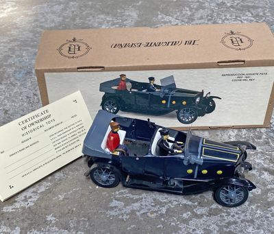 une boîte contenant une petite voiture et une carte, posée par terre