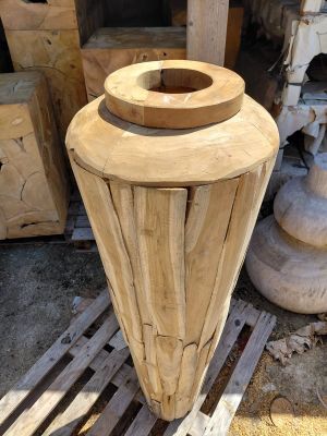 a wooden vase that is sitting on a pallet