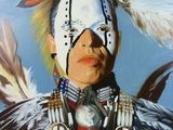 an oil painting of a native american man wearing a feather headdress