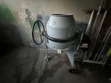 a large white drum sitting on a cart in a room
