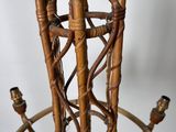 a wicker table with a glass top and a metal base