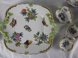 a picture of a table with a plate, bowl, and cups
