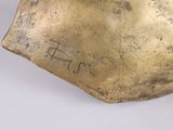 bronze sculpture of a bird on a rock on a white surface