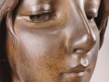 bronze statue of a woman with her eyes closed and her eyes closed