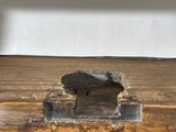 a hole in the floor where a piece of wood has been removed