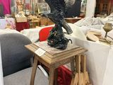a statue of an eagle sitting on a table in a store