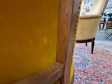 a yellow chair sitting in the middle of a living room