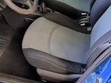 the interior of a blue car with a steering wheel and a dashboard